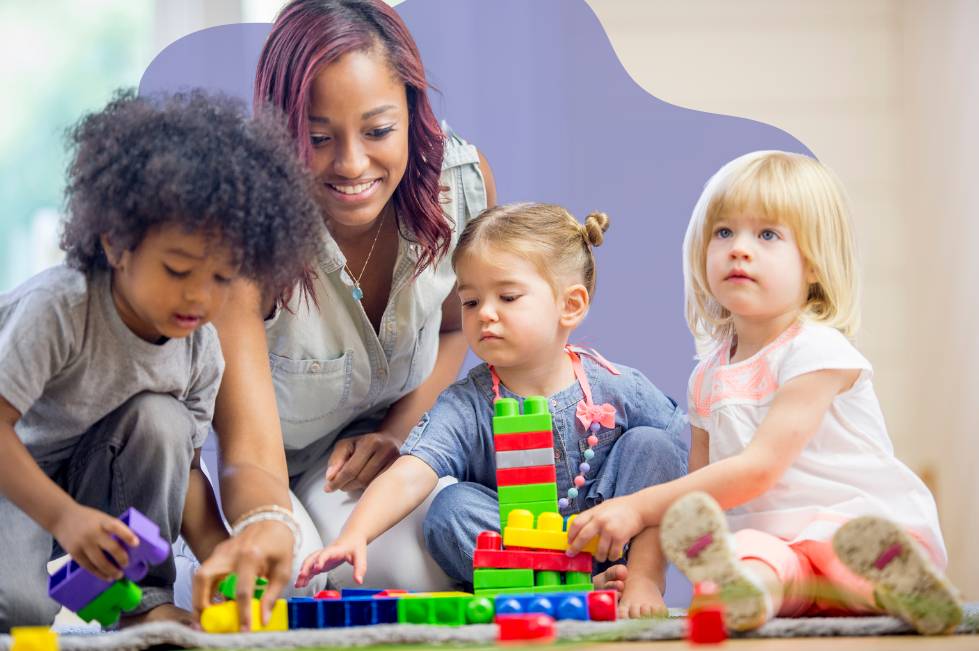 A teacher playing with three toddlers